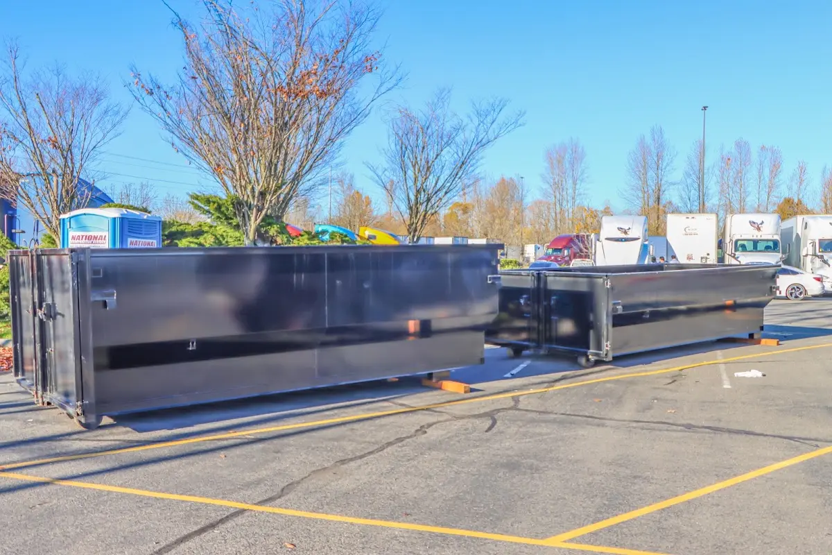 Professional dumpster rental service with roll-off container on residential driveway in Wade Hampton